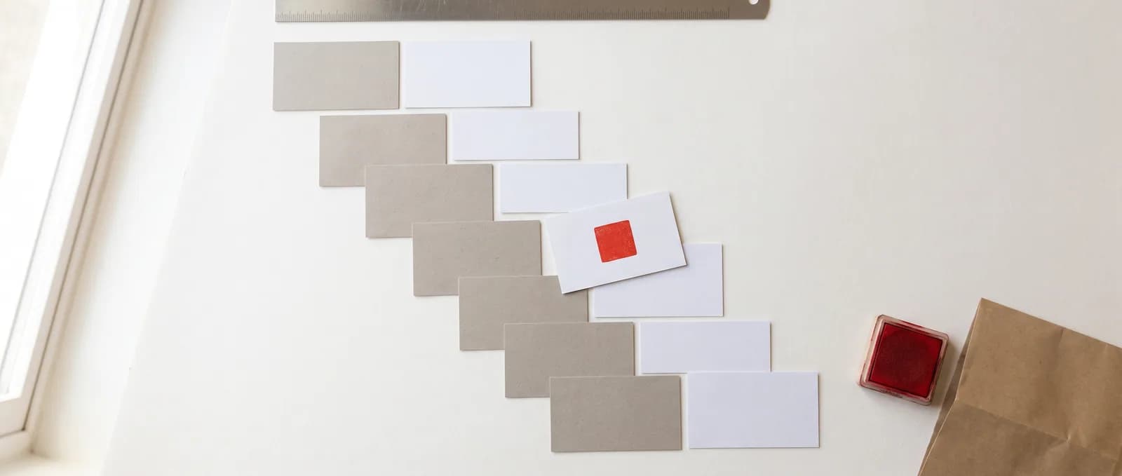 Blank cards laid out in two alternating columns like a back-and-forth exchange, one marked with a small red square.