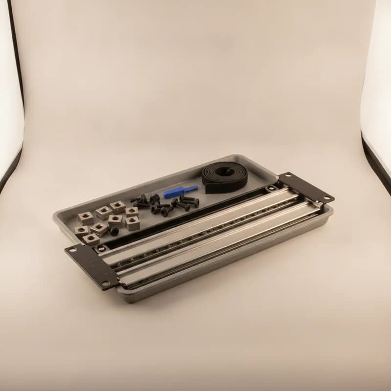 A rack hardware set — extended slide rails, cage nuts, screws with washers, an insertion tool and a hook-and-loop strap.