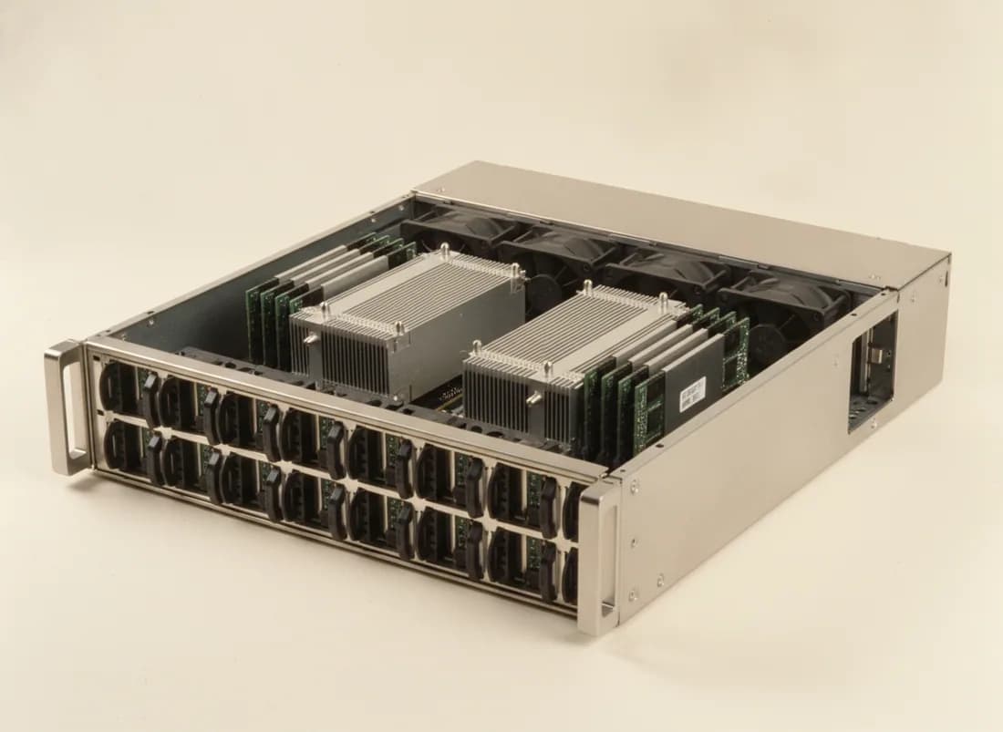 A 2U dual-socket rack server with the lid off, showing drive bays, twin CPU heatsinks, memory slots and a fan wall.
